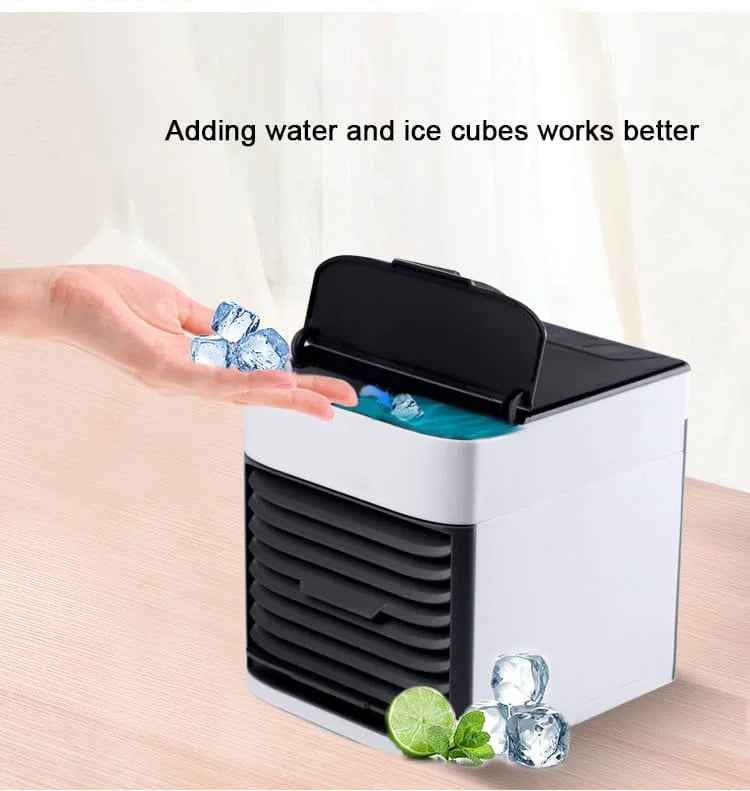 Small air cooler with ice cubes being added to it on a light background