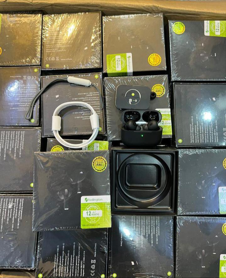 Stack of black electronic device boxes with a white cable on top