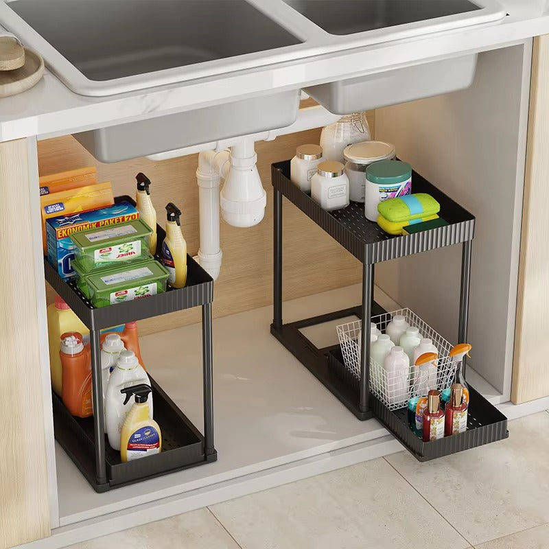 Under-sink kitchen storage rack with various cleaning supplies.