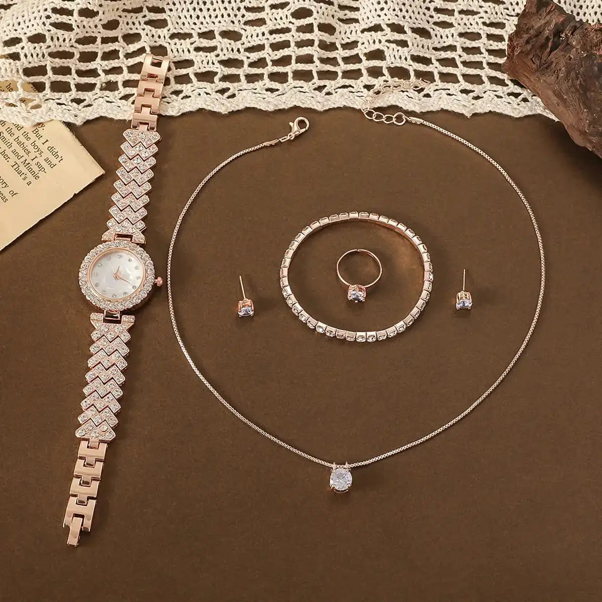Diamond style watch and necklace set for women shining under room light.