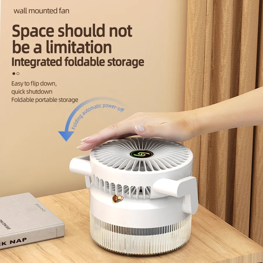 Wall-mounted fan with foldable storage on a wooden surface, hand interacting with it.