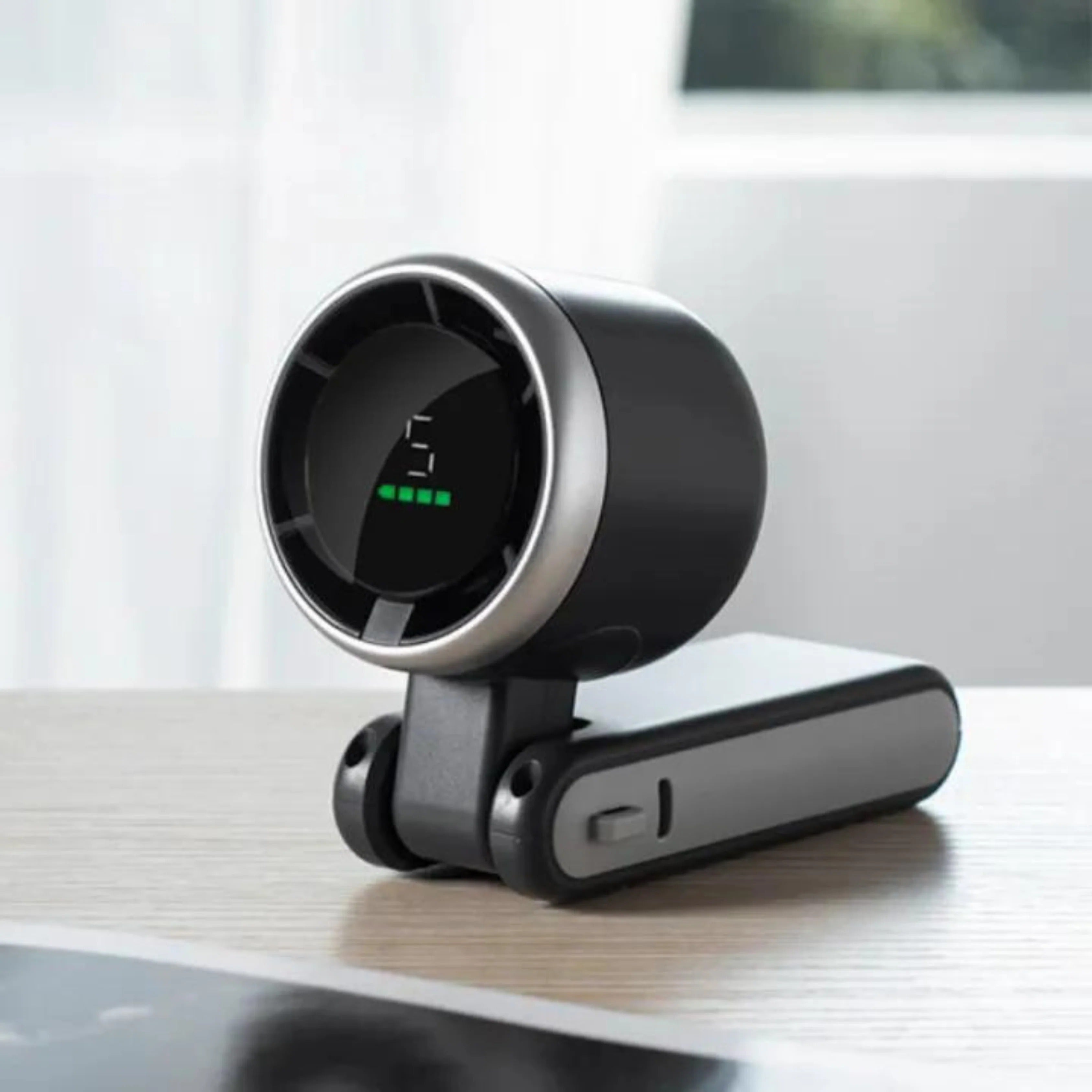 Silent portable fan with 5 speed adjustment cooling a user at their office desk.