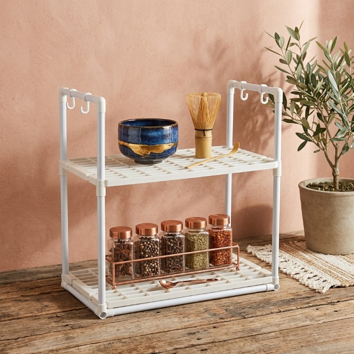 Top shelf of the 2 layer microwave stand securely holding plates and bowls