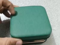 Jewellery organizer box with dedicated compartments for rings and earrings.